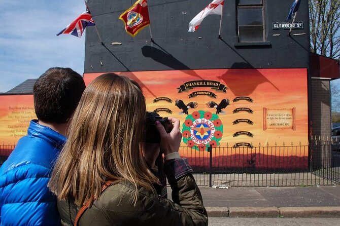 2 Hours Republican & Loyalist Mural Black Taxi Tour from Belfast - International Mural Wall on Divis Street: global headlines, painted large